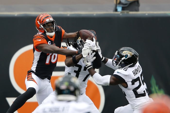 Oct 4, 2020; Bengals wide receiver A.J. Green (18) goes up for the pass while defended by Jaguars cornerbacks Tre Herndon (37) and D.J. Hayden (25). Mandatory Credit: Joseph Maiorana-USA TODAY